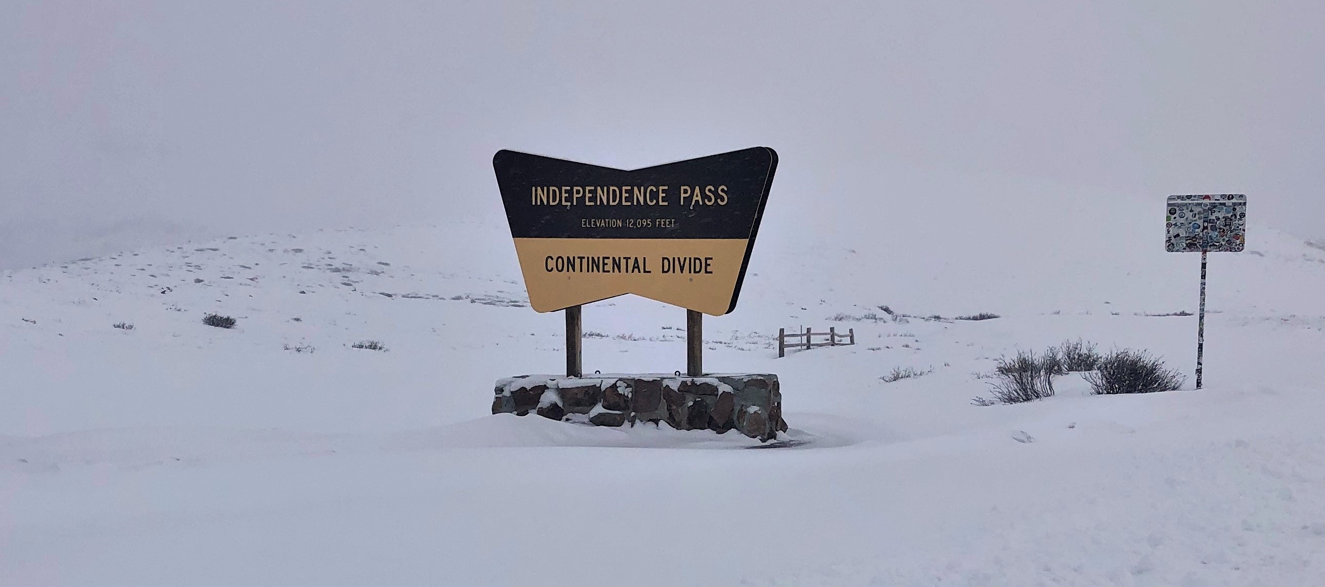 Independence Pass sign in the snow detail image