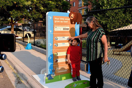 Child and parent interacting with size chart at Safety event detail image