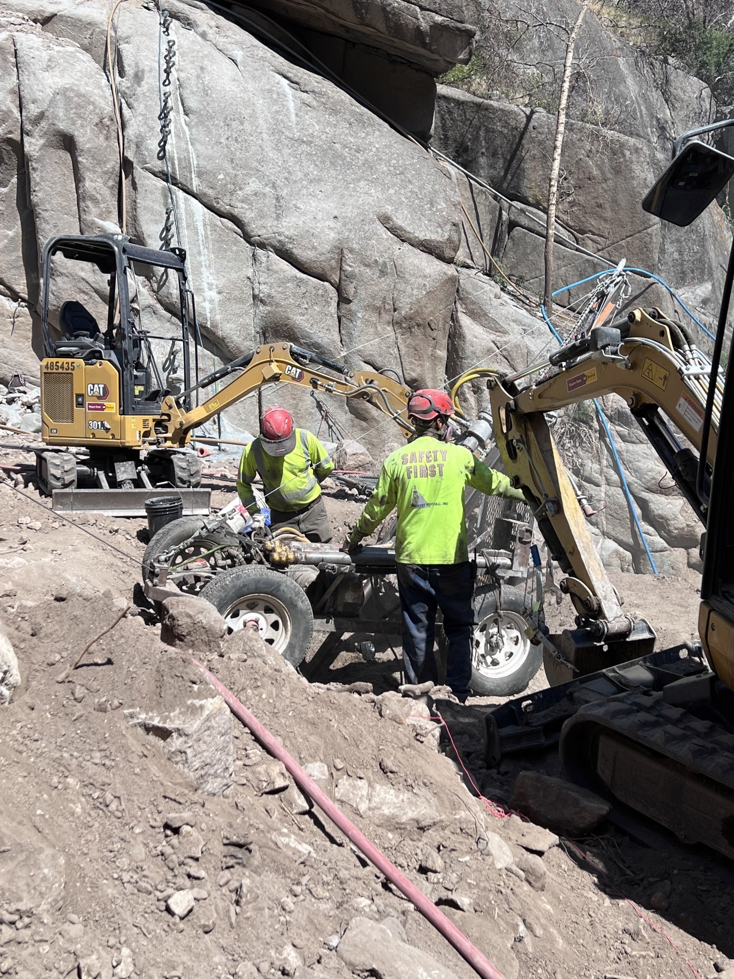 Crews preparing equipment to haul up the side of a rockface detail image
