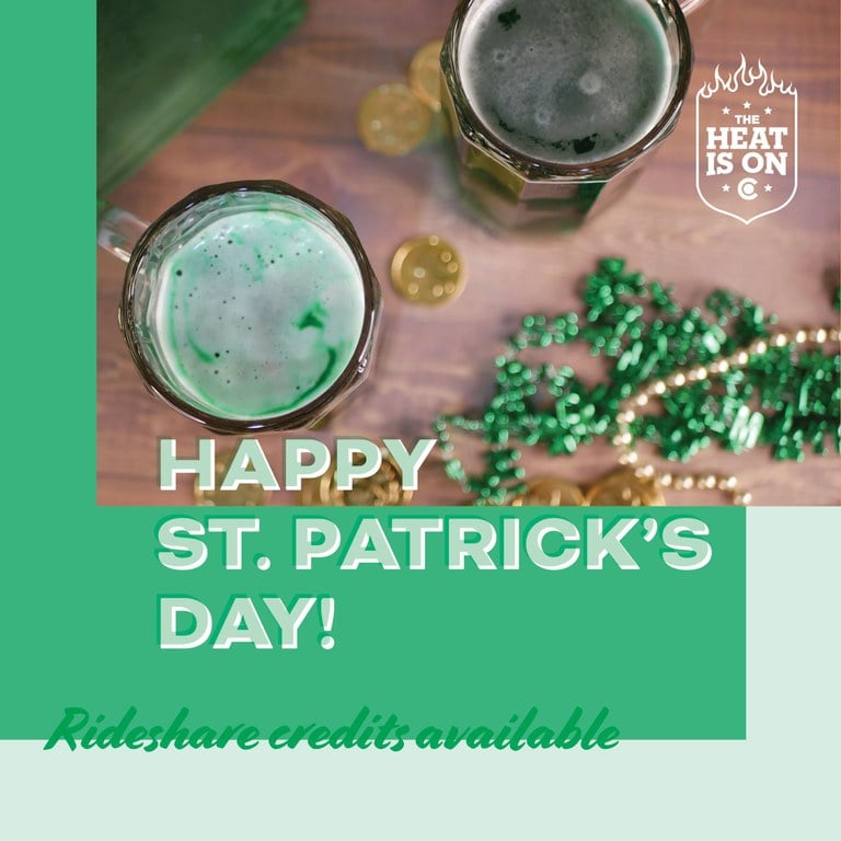 Alcoholic beverages and St. Patrick’s Day festive decorations promoting The Heat Is On enforcement period, text overlay reads "Happy St. Patrick's Day! Rideshare credits available.”