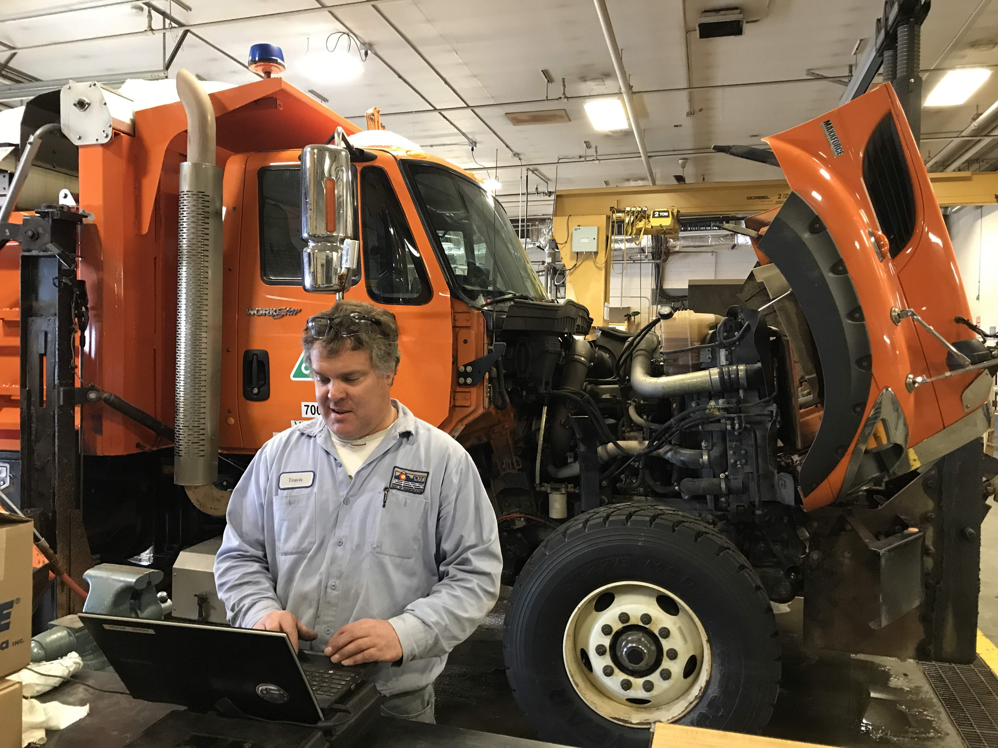 CDOT_maintenance_employee_on_computer_with_snowplow.jpg detail image