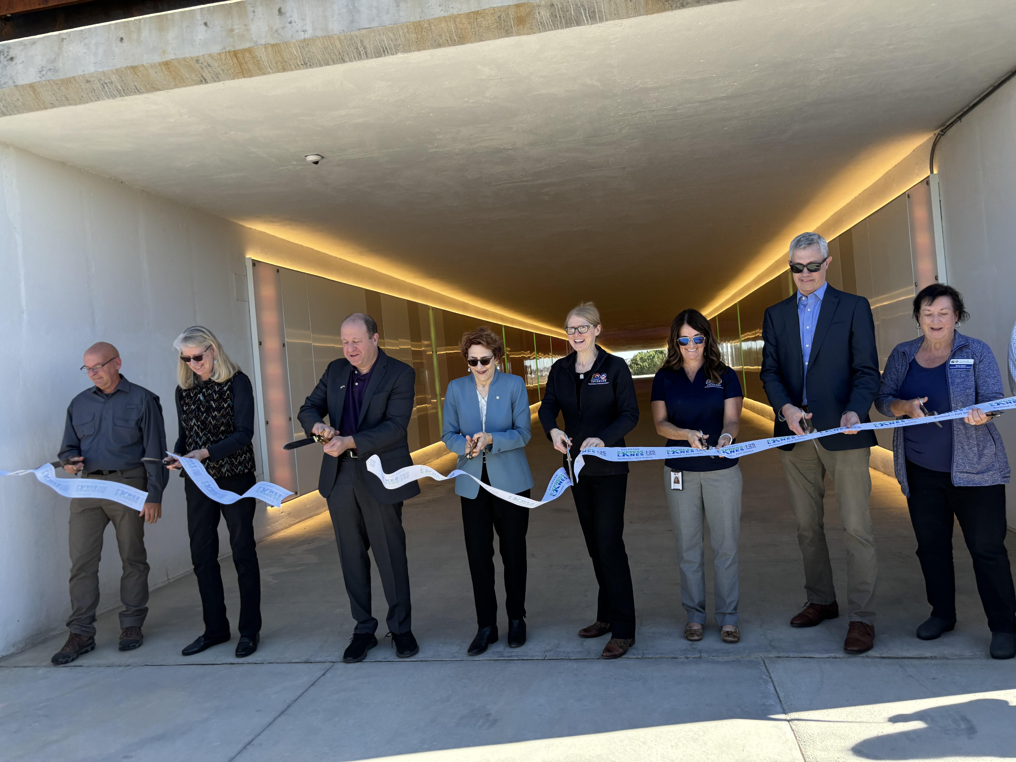 Governor Jared Polis US Department of Transportation Deputy Secretary Polly Trottenberg, CDOT Executive Director Shoshana Lew and local partners cut ribbon at Mobility Hub.png detail image