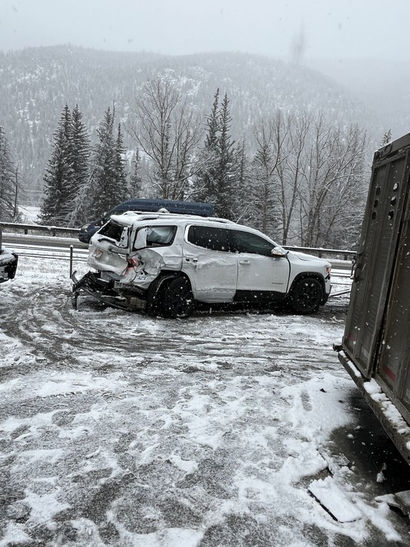 A white sports utility vehicle with dented rear crashed into a guardrail. Crash image captured from Monday, Feb. 16, I-70 westbound closure near Empire Junction/ Exit 232 and Georgetown/ Exit 228.