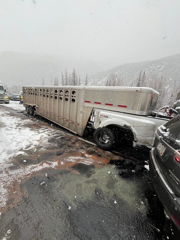 A crash involving a white truck hauling a multi-horse transporter. Crash image captured from Monday, Feb. 16, I-70 westbound closure near Empire Junction/ Exit 232 and Georgetown/ Exit 228.