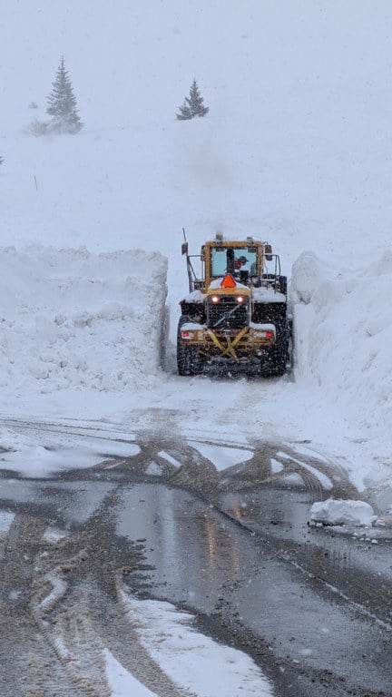 CDOT snow removal equipment plowing several feet of snow on Loop Road by the EJMT.