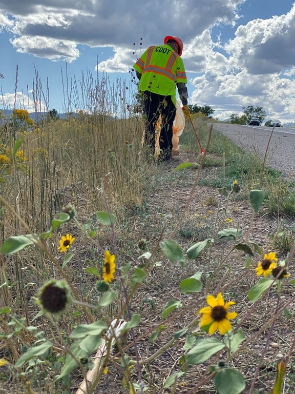 CDOT worker picking up trash on the highway