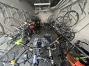 A photo of an secure indoor bike storage room filled with bicycles. thumbnail image