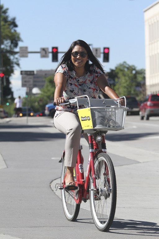 A woman on a red bike bikes to work