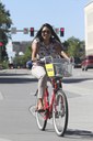 Woman on a red bike bikes to work thumbnail image