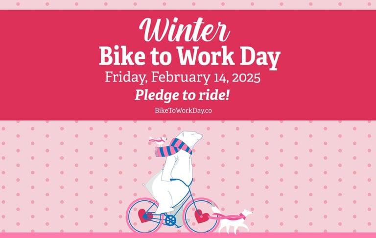 Winter Bike to Work Day Graphic. The image features a polar bear in a pink and blue scarf riding a bicycle with heart-shaped wheel hubs, accompanied by a white bird and a white fox, both wearing pink scarves, in front of a pink polka dot background. At the top of the image, a pink banner with white text says "Winter Bike to Work Day Friday, February 14, 2025 Pledge to ride! BiketoWorkDay.co"