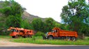 Tandem axle dump trucks (right) and Grade-Alls (left) are used to clean ditches and stream beds to keep water flowing, and prevent flooding or erosion. thumbnail image