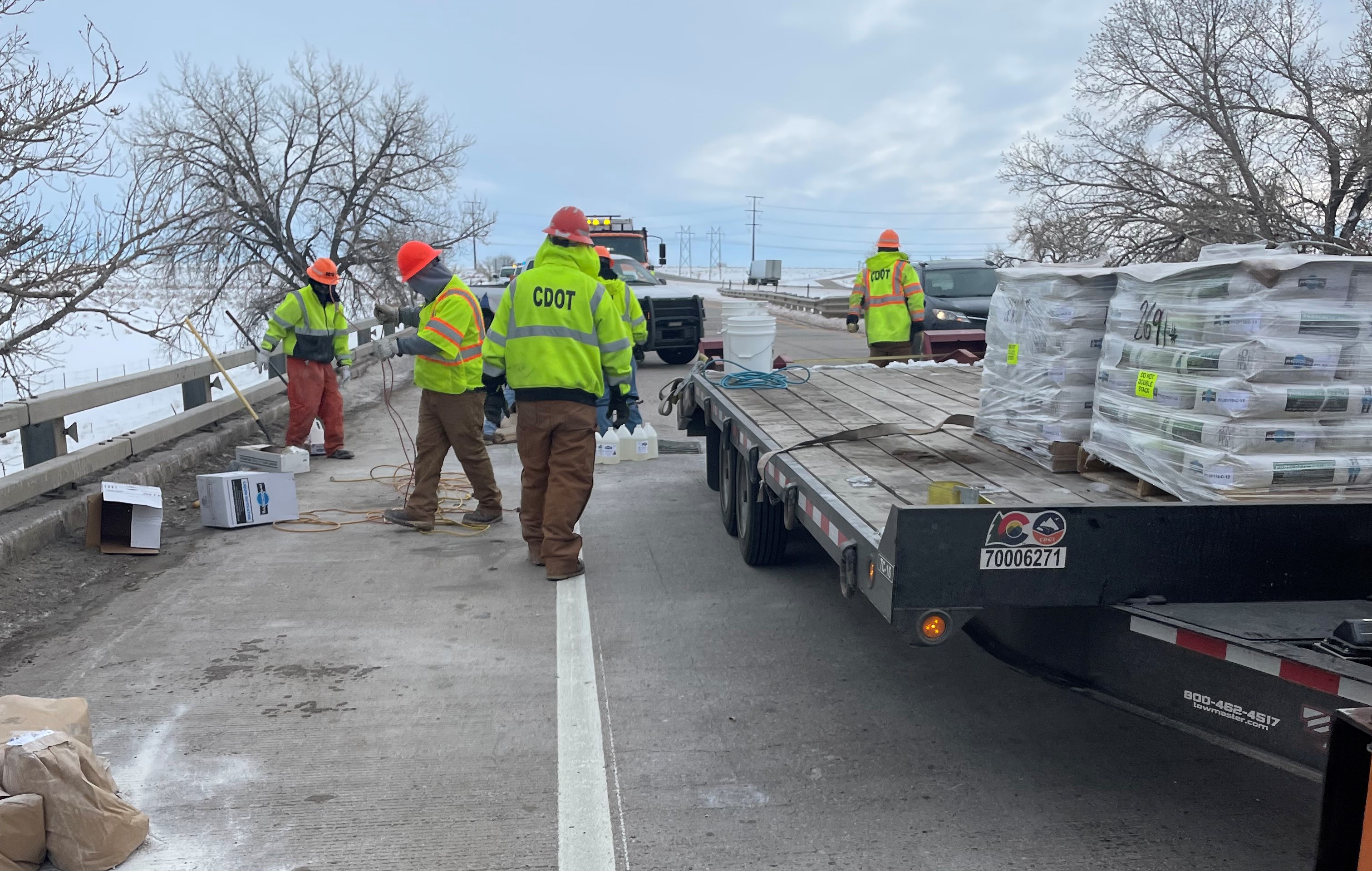 CDOT crews with truck and materials repairing bridge