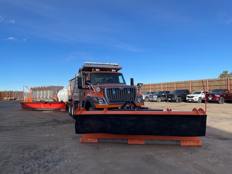 A CDOT tow plow pulls a trailer with a second tow blade, allowing for faster and more efficient snow removal)
