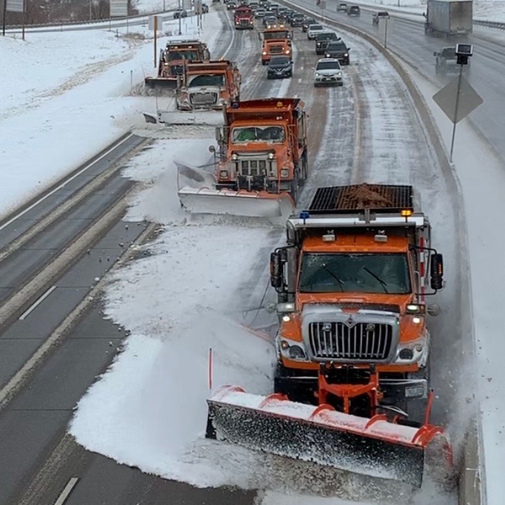 Plows in echelon formation on the highway