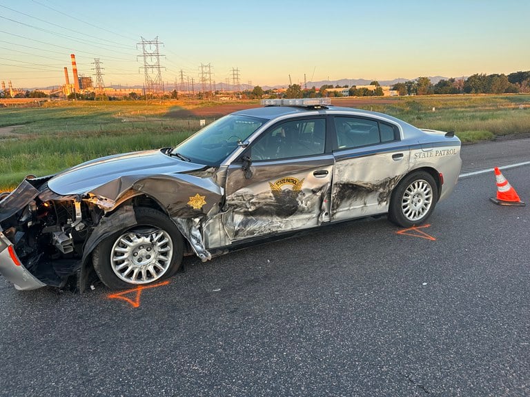 Wrecked Colorado State Patrol vehicle on the roadside. The patrol vehicle was hit by a passing motorist.