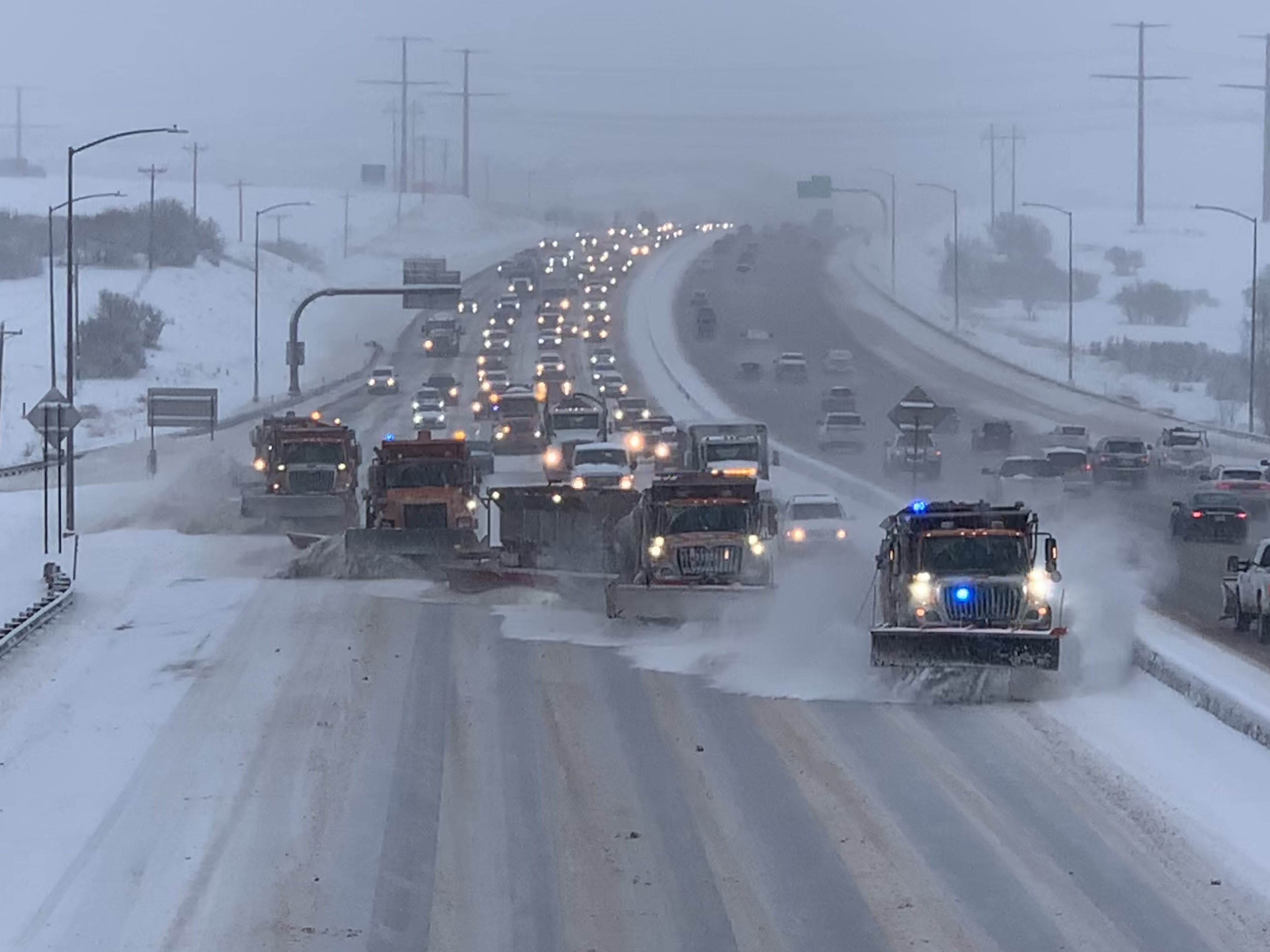 CDOT snowplows in tandem formation plowing a major Colorado highway 