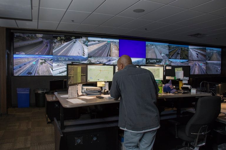 Traffic Operations Center Dispatcher watching several screens showing traffic conditions