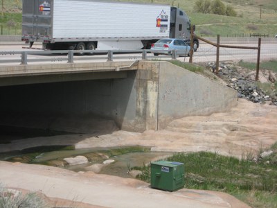 View of green sampling security box located at the discharge point into live Colorado state waters.