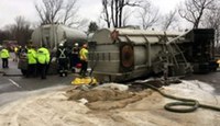 Chemicals spilled on a highway with employees working to clean it up