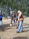 Mike Holmes, EPA and Medill Barnes with the Silver Dollar Metro District take a swing with gold plated picks to break ground on the 119 Main Street South Construction project. thumbnail image