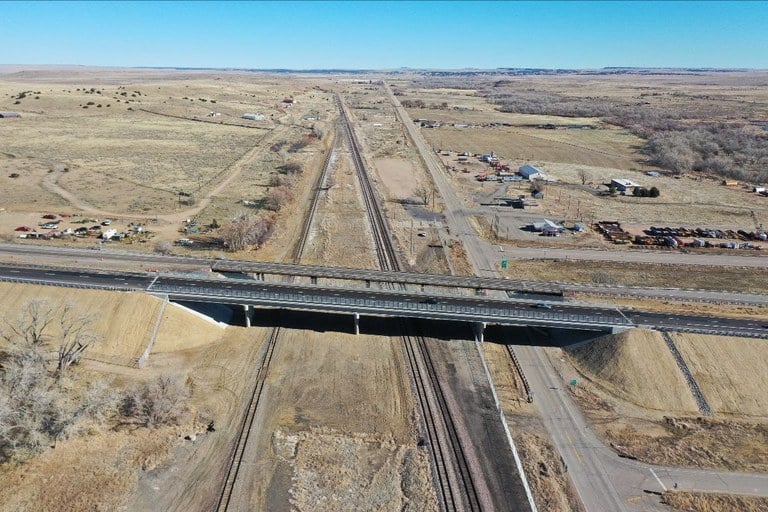 Interstate 25 and Colorado Highway 10 from west of I-25 highlighting the new bridge and pavement.