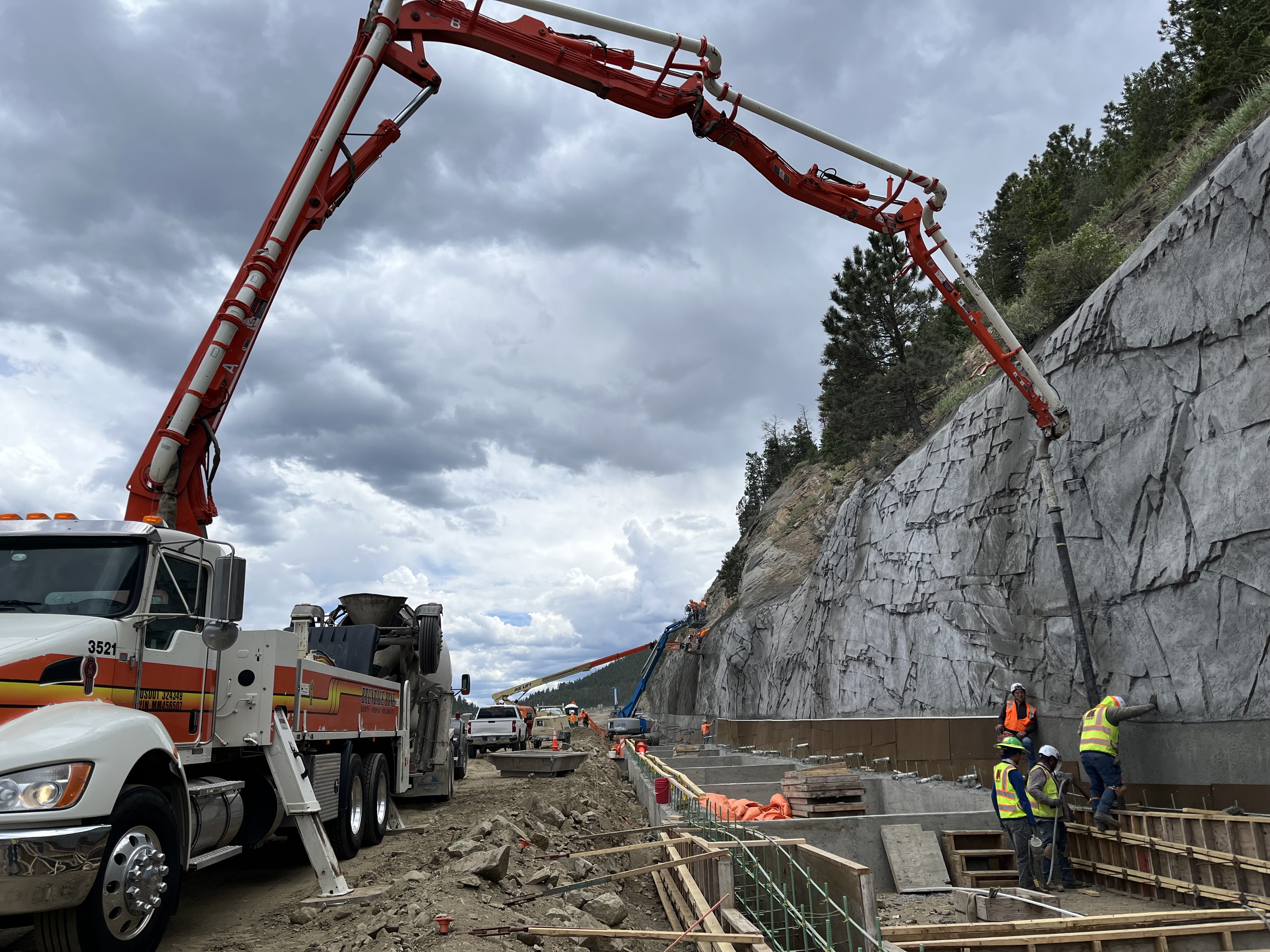 I-70 Floyd Hill Truck Pumping Concrete for Super Ditch and Shotcrete Spraying and Sculpting in Background.jpg detail image