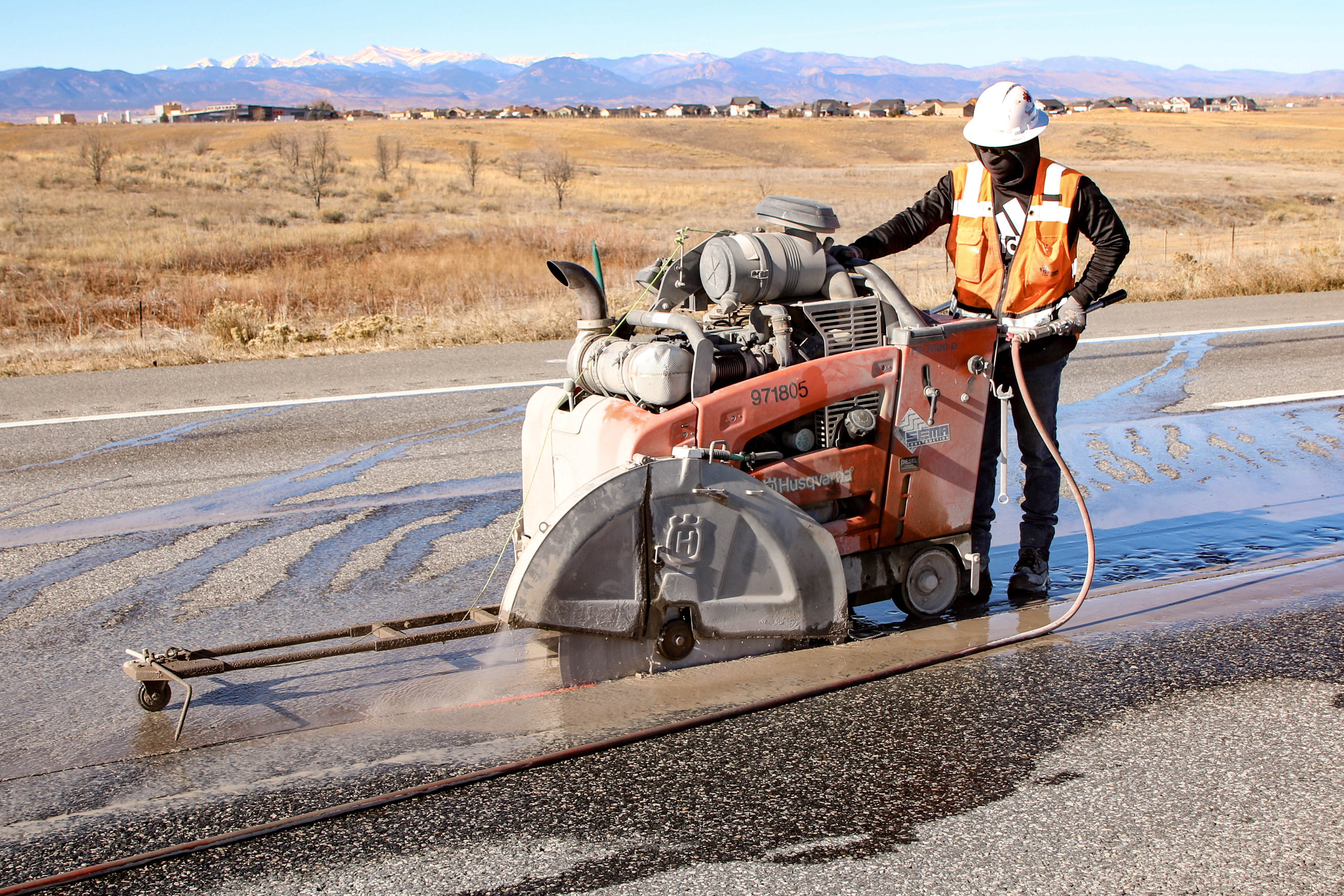 Construction Worker Cutting Asphalt detail image