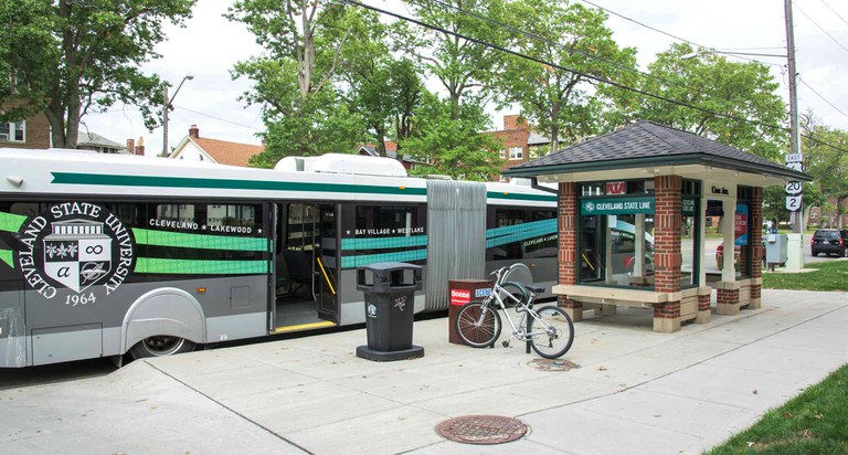 Bus rapid transit shelter in Cleveland, Ohio. The shelter features a canopy, benches and accessible seating, a bike rack, and maps.