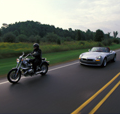 Motorcycle and car on the highway; used for share the road/watch out for motorcycle tips. thumbnail image