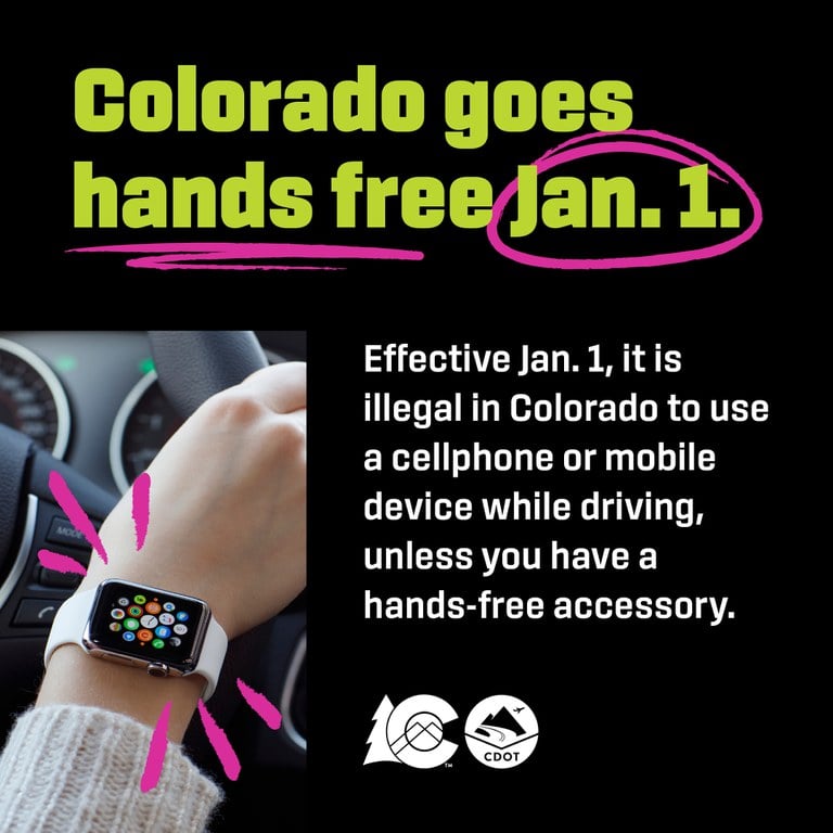 A person’s wrist wearing an Apple Watch with green and white text and pink doodle decals explaining the new Hands-Free Law.