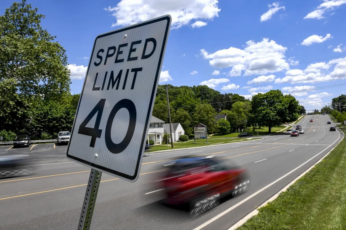 Car Speeding Past Speeding Limit Sign.jpeg detail image